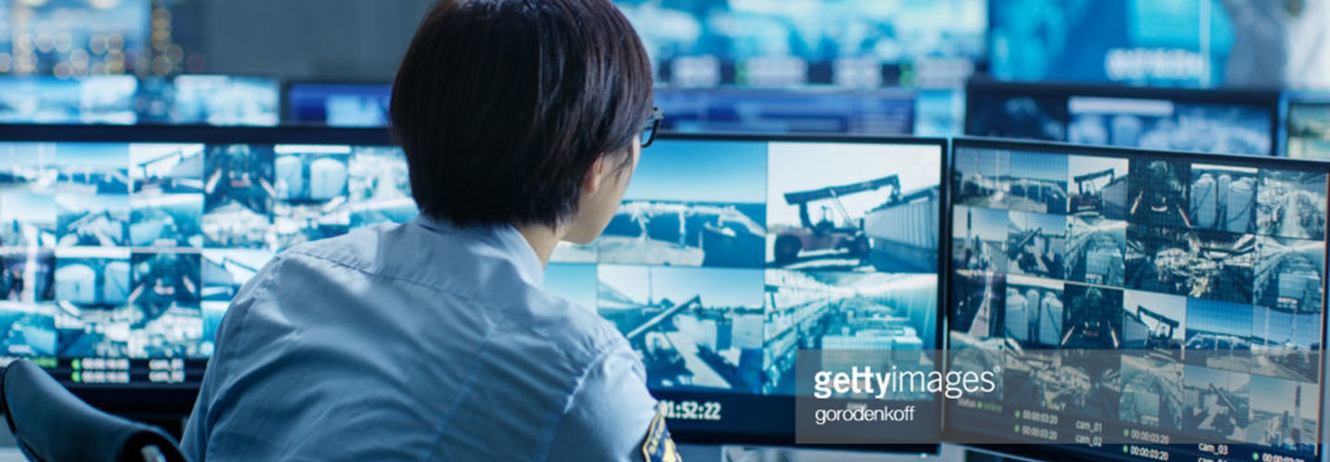 In the Security Control Room Officer Monitors Multiple Screens for Suspicious Activities.