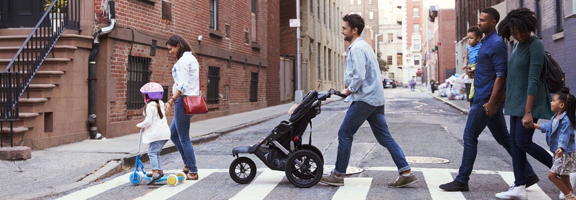 Two families with daughters crossing road