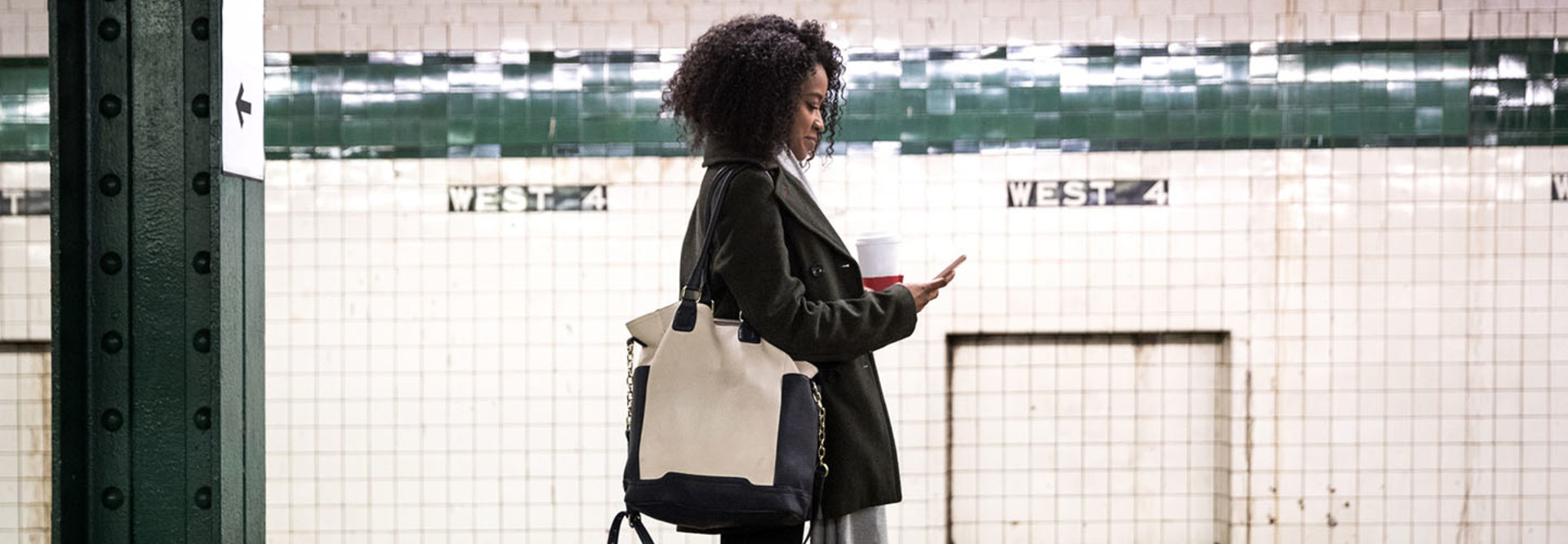 Young woman waiting for the subway train in New York, USA.