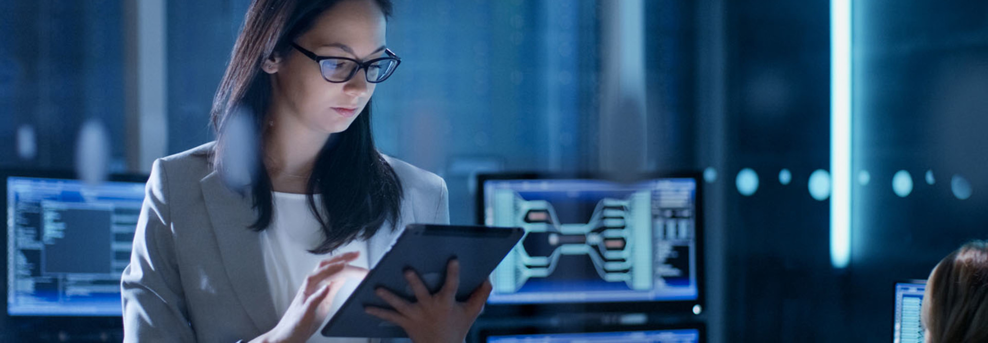 Young Female Government Employee Wearing Glasses Uses Tablet in System Control Center. 