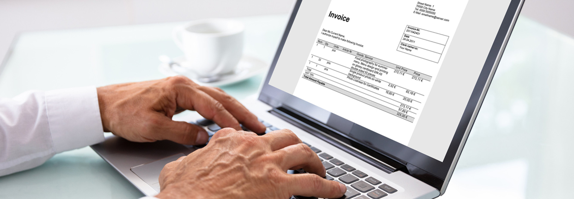 Man looking at an invoice on a laptop