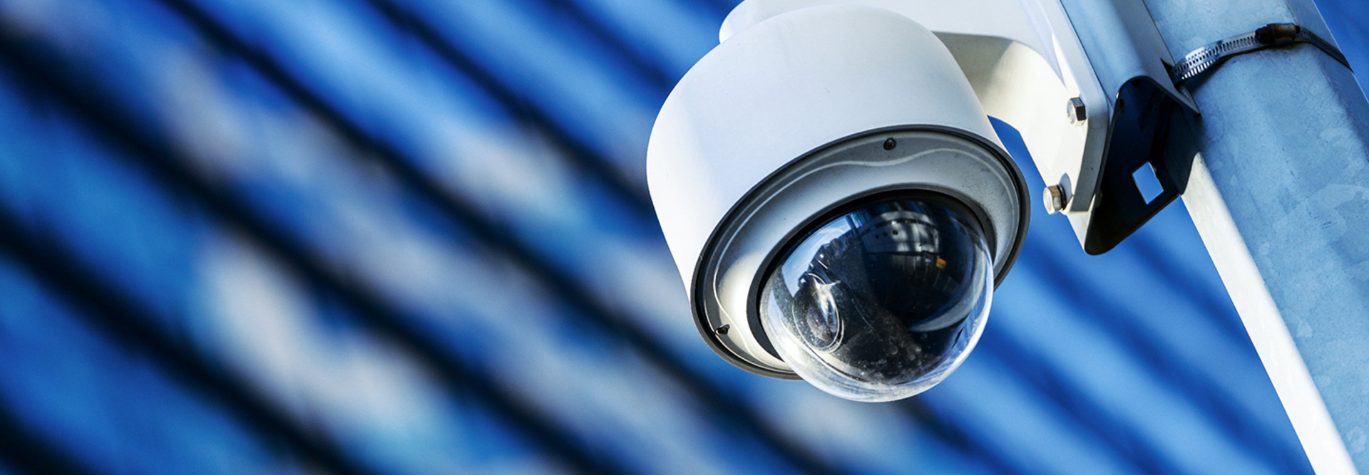 Surveillance camera on a lamp post in a city