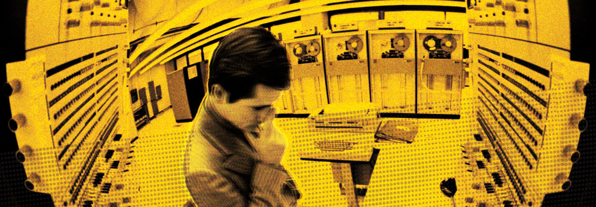 Man standing in front of a mainframe 