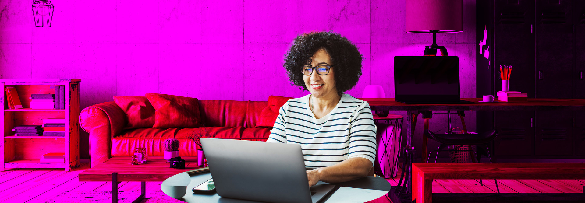 Person sitting in a living room on a laptop. 