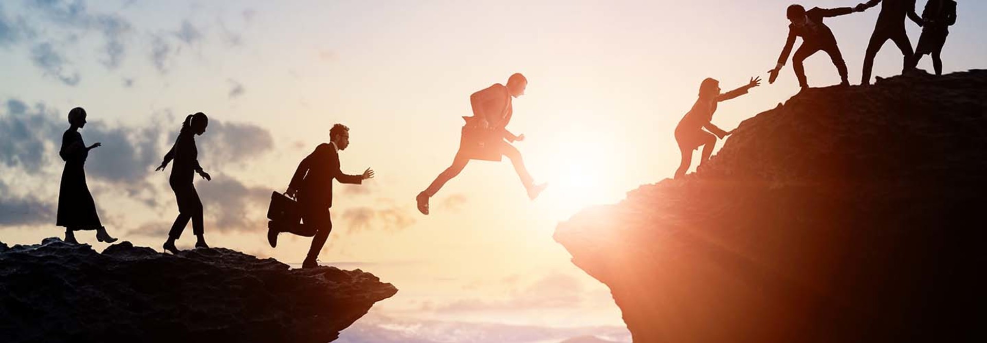 Challenge of business concept. Group of businesspeople climbing a mountain. Teamwork. Success.