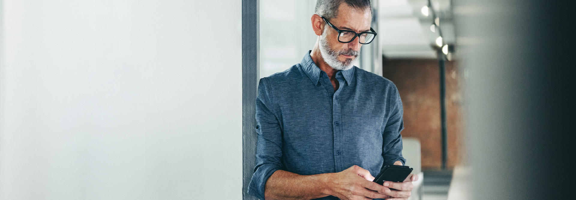 Person using a smartphone in an office