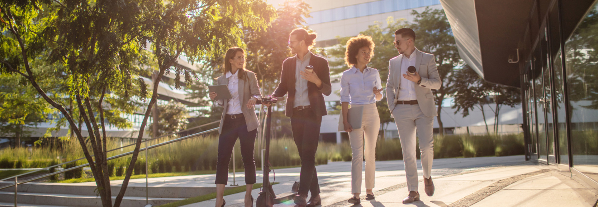 Group of business people waking outside office building