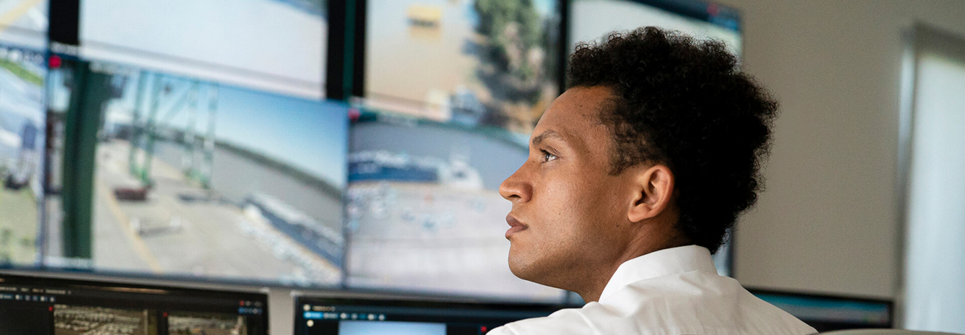 Security worker watching video wall