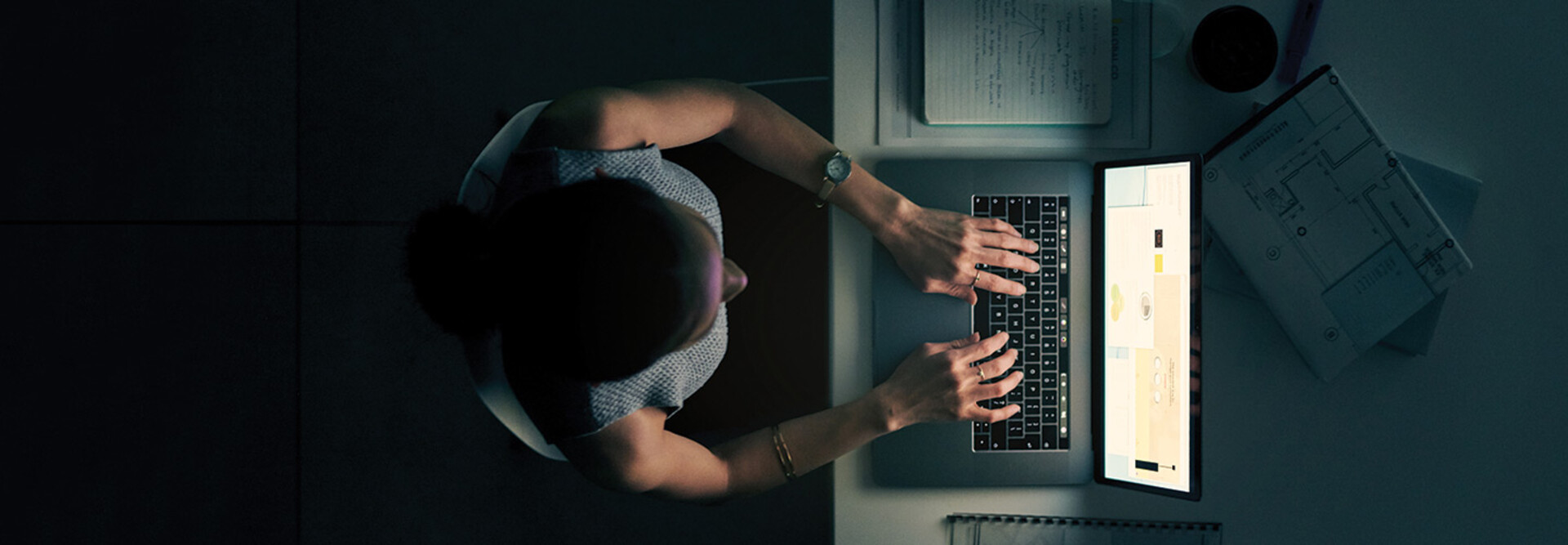 Employee using computer in a dark room