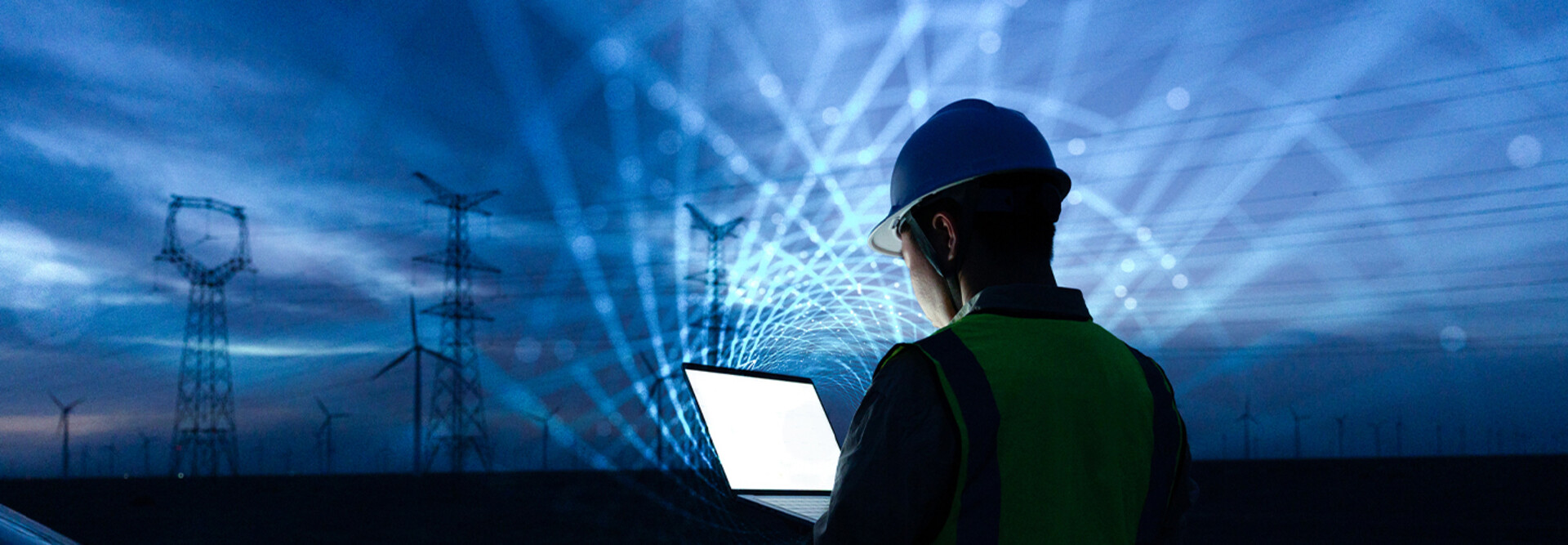 workman with laptop and data lights in the sky