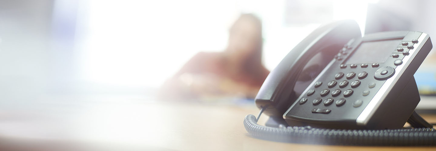 Telephone on desk in call center or office