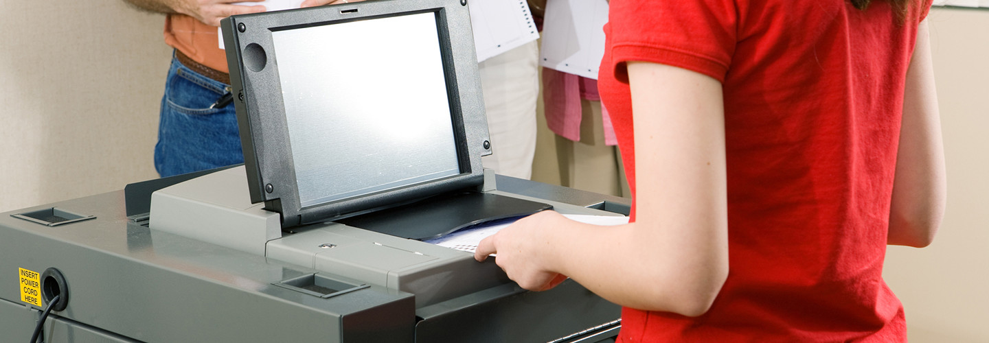 Inserting a ballot into a ballot scanner 