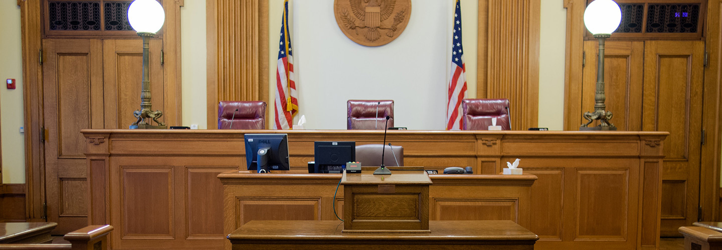 Empty courtroom with three judges' chairs 