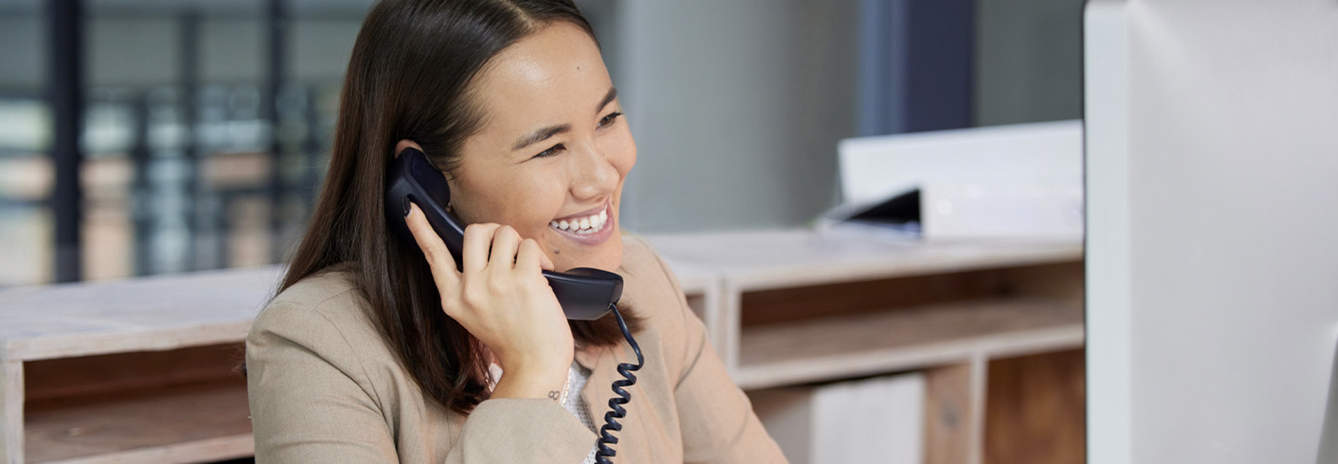 Person talking on the phone at computer