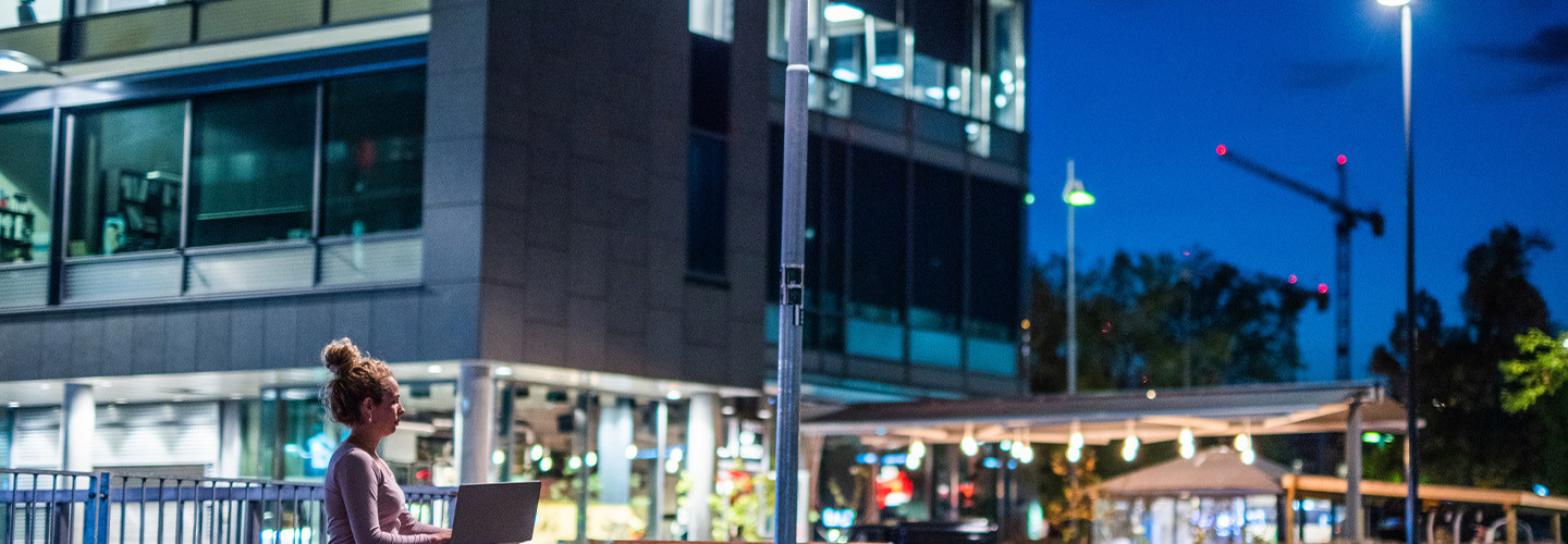 Person working next to smart streetlight