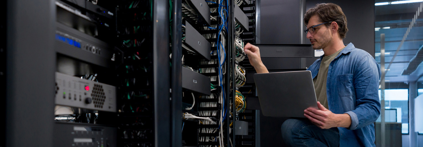 IT support technician fixing a network server