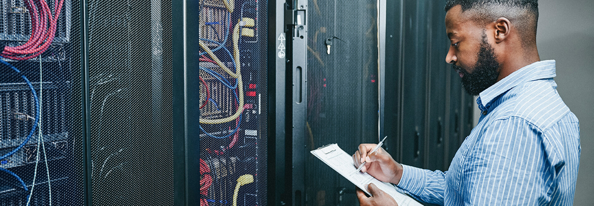 man managing a server room