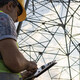 Person using tablet to assess power grid