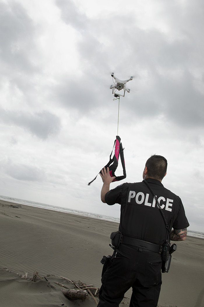 Officer Clint Potter pilots a DJI drone in a test of its search and rescue capabilities in Ocean Shores, Wash.