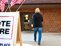 Woman walking into a polling place to vote