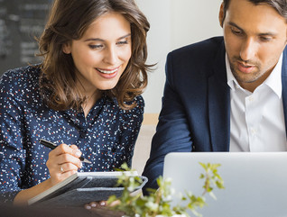 A pair of male and female executives working together 