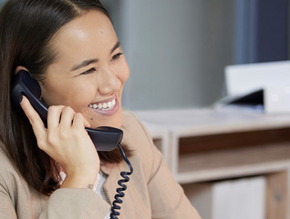 Person talking on the phone at computer