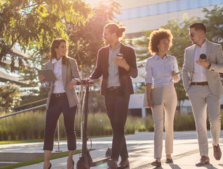Group of business people waking outside office building