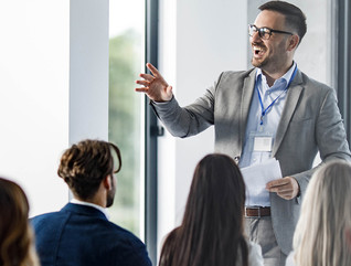 Person presenting at a conference