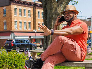 Person talking on the phone in a small town