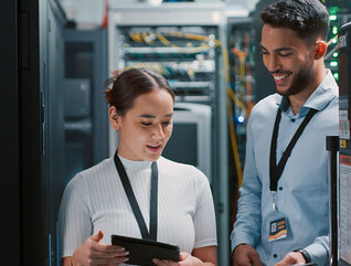 Colleagues working together in a server room
