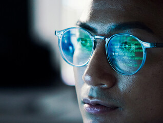 Code reflected in coder's glasses