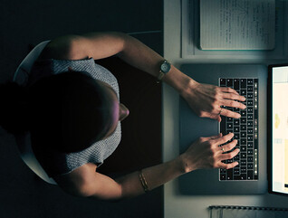 Employee using computer in a dark room