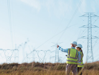 Utility workers examining power lines
