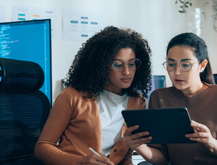 Coworkers viewing tablet