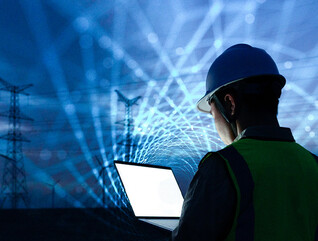 workman with laptop and data lights in the sky