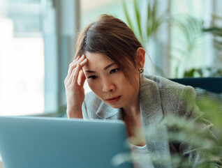 Frustrated person using computer