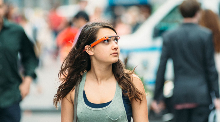 Teenage girl wearing Google Glass in Times Square