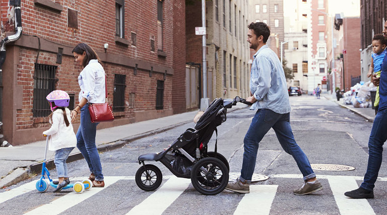 Two families with daughters crossing road