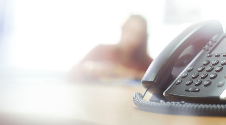 Telephone on desk in call center or office
