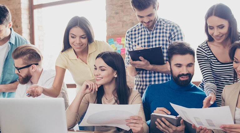 Close up of meeting of colleagues, all of them are in casual clothes, discussing the company`s development strategy at nice cozy office