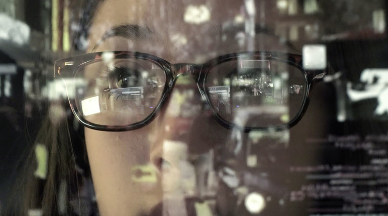woman concentrating on a touch screen display