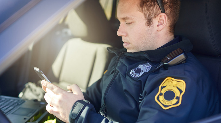 Police officer using a smartphone 