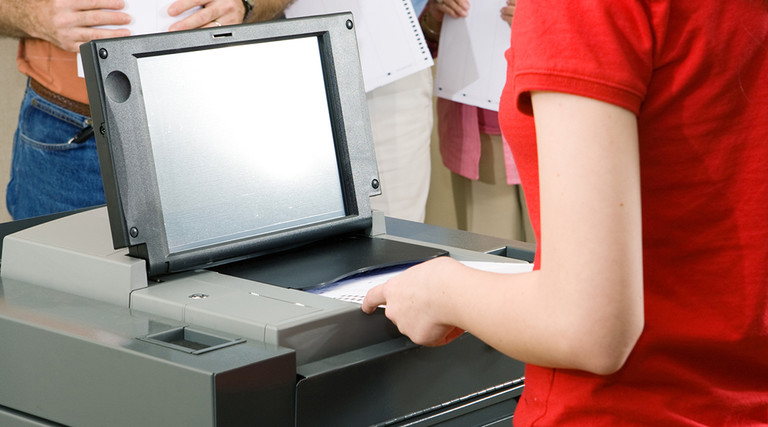 Inserting a ballot into a ballot scanner 
