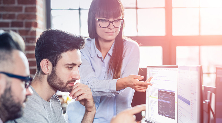 Local government cybersecurity team, a woman and two men at computers