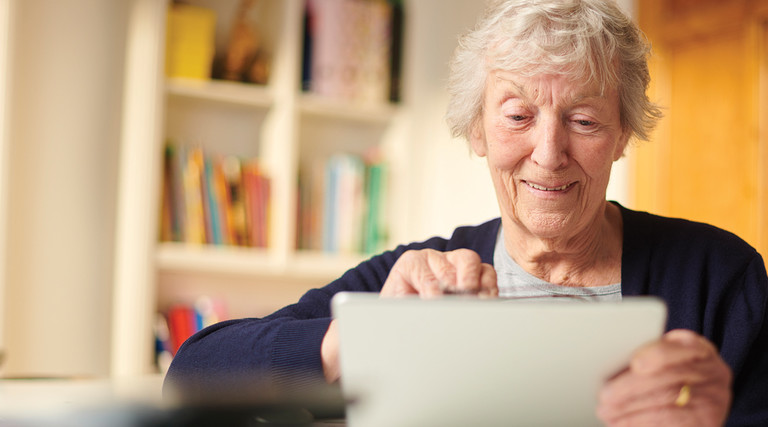 Old woman using a tablet 
