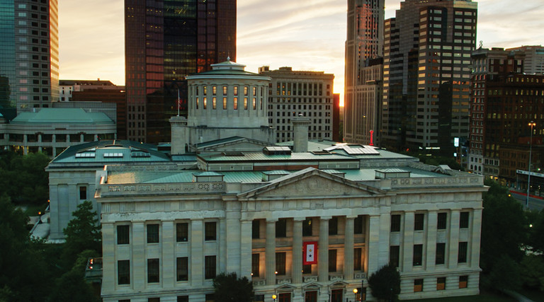 Aerial establishing shot of the Ohio Statehouse in Columbus at sunset.