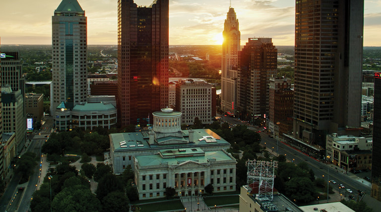 Aerial establishing shot of the Ohio Statehouse in Columbus at sunset.