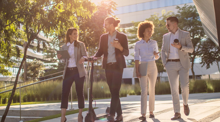 Group of business people waking outside office building