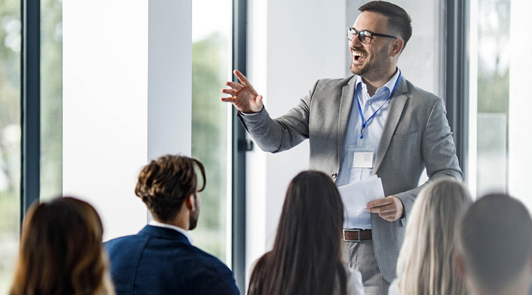 Person presenting at a conference