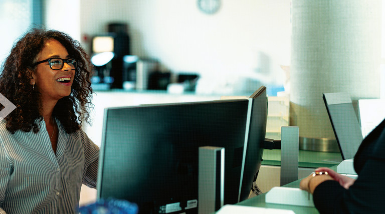 People speaking at a front desk